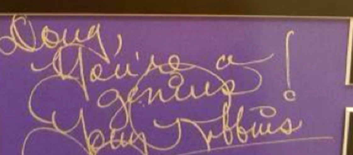 Handwritten note from Tony Robbins to Doug Allen that reads: Doug, you're a genius!